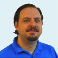 White male with brown hair, mustache, and goatee wearing a royal blue polo shirt.